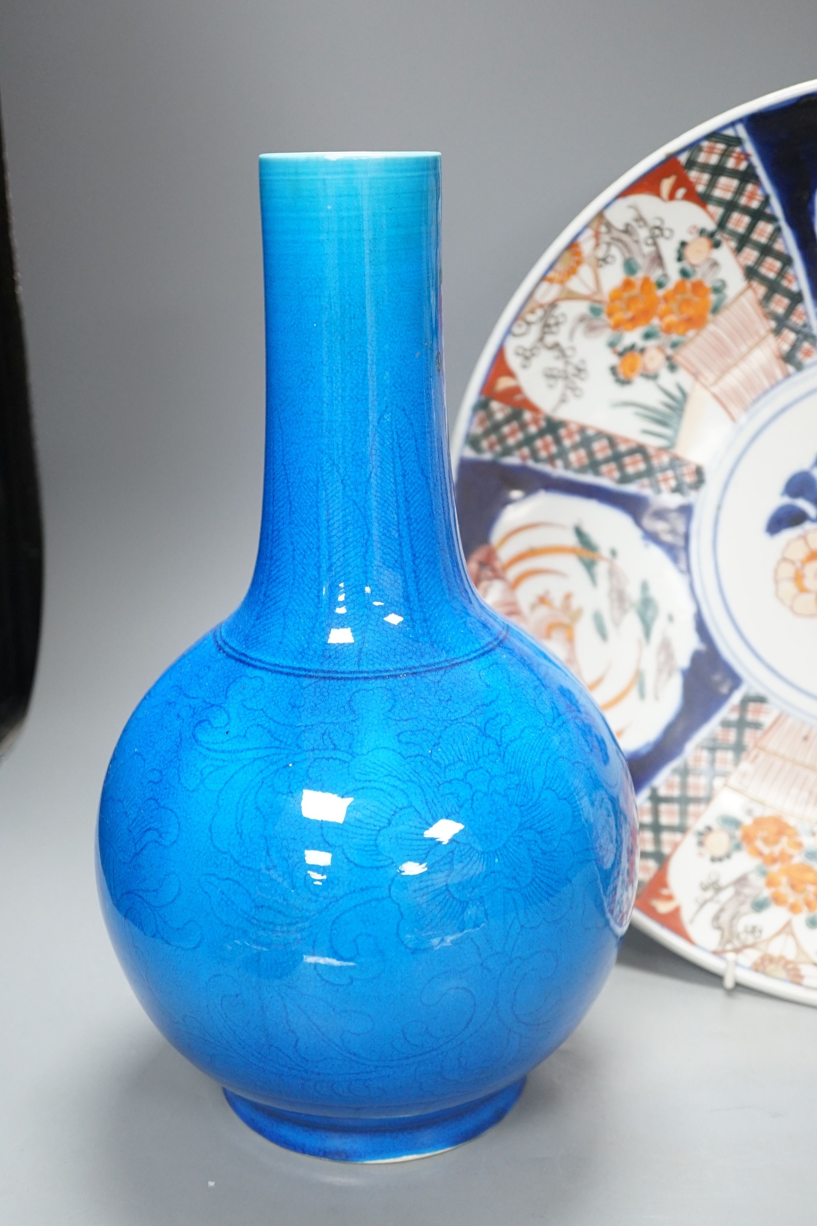 A large Japanese turquoise glazed bottle vase and an Imari dish, dish 37 cms diameter.